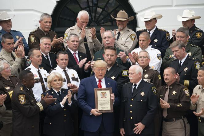 President Donald J. Trump is presented with a plaque of recognition from Sheriff Thomas Hodgson of Bristol County, Massachusetts, Thursday, Sept. 26, 2019, at the South Portico of the White House. (Official White House Photo by Joyce N. Boghosian)