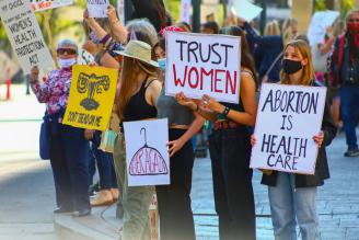 a group of protesters holding pro-abortion signs