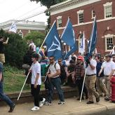 People carrying Identity Evropa flags march in Charlottesville, August 16, 2017