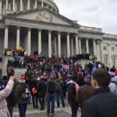 A group of right wing protesters outside the Capitol building in Washington DC. They are climbing the Stairs of the building.