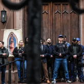 A group of people standing in front of a church.
