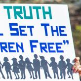 A sign that says "The Truth shall set the children free."