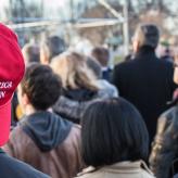 A Person wearing a MAGA hat backwards.