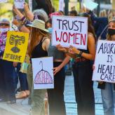 a group of protesters holding pro-abortion signs