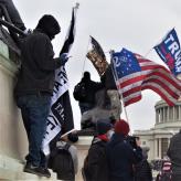 People holding flags of various groups like 2 percenters and Trump flags.