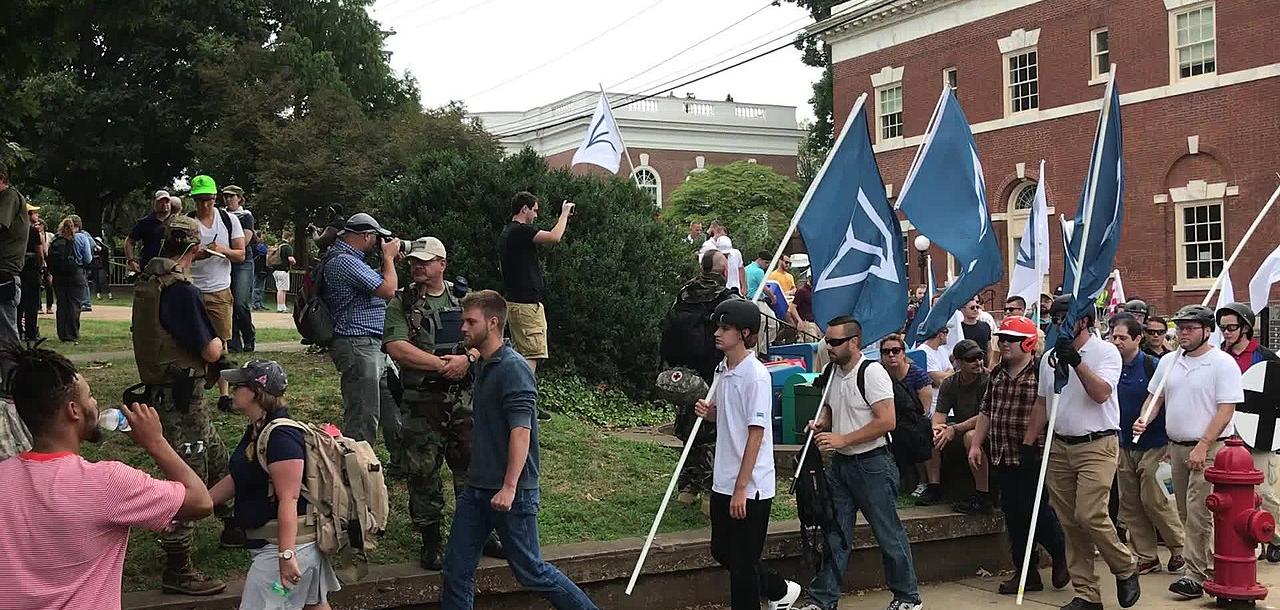 People carrying Identity Evropa flags march in Charlottesville, August 16, 2017