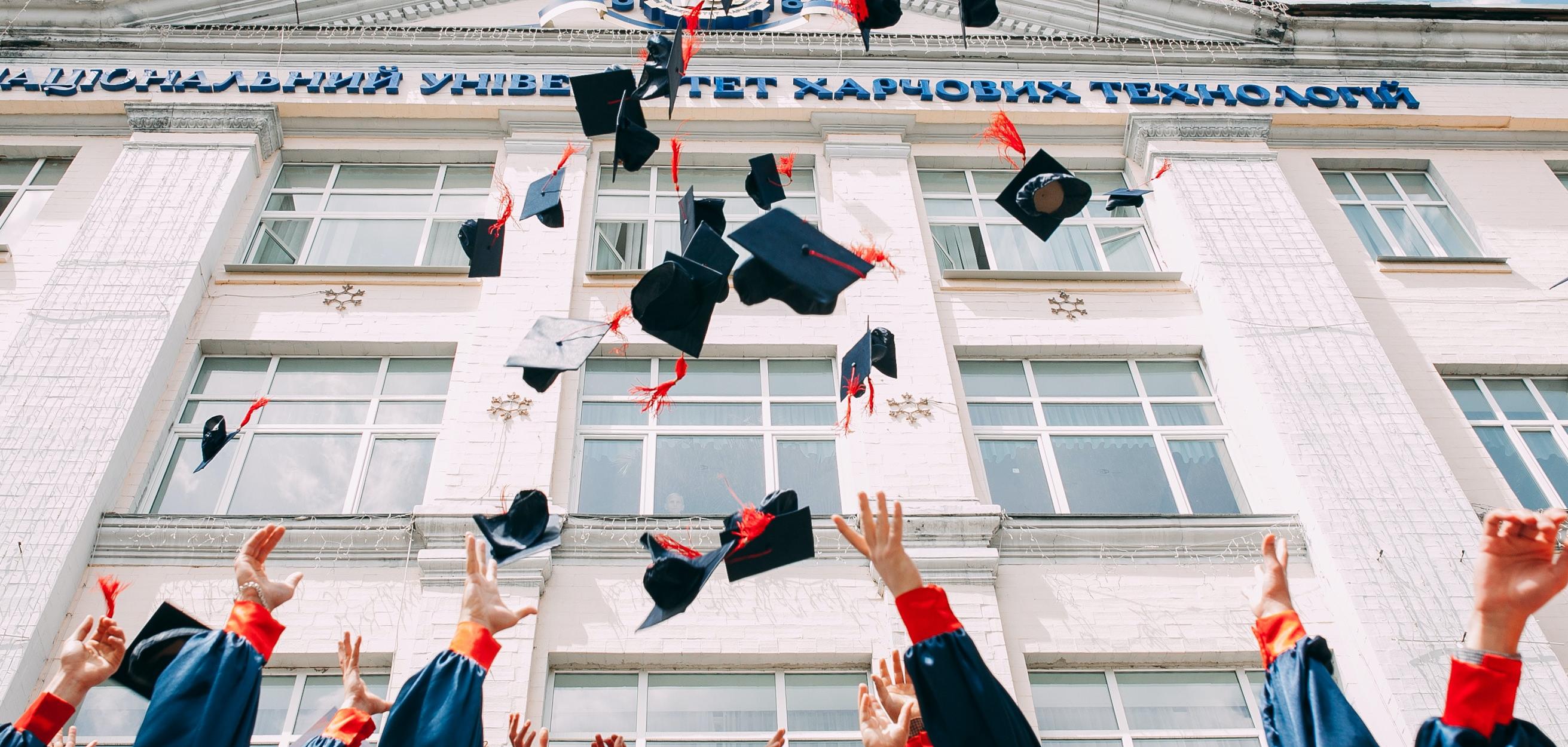 Graduation hats being thrown in the air