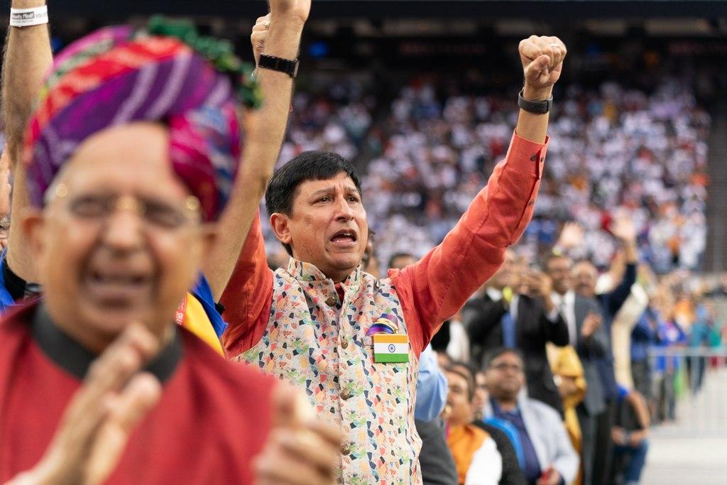 Group of people cheering with their arms in the air